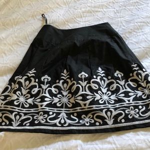 Black and white embroidered Inc. skirt.